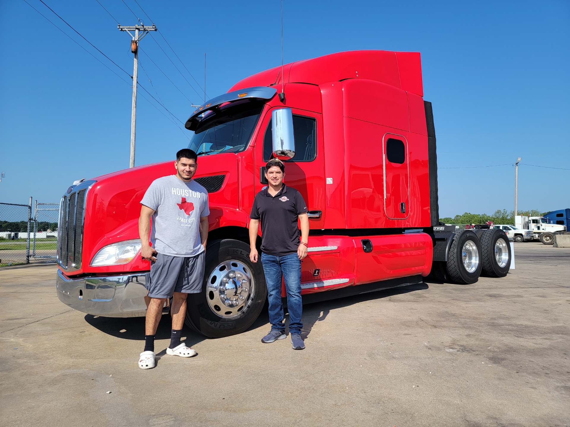 Texas Xpressway team standing beside a red truck